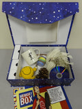 A blue memory box with white stars on, filed with items